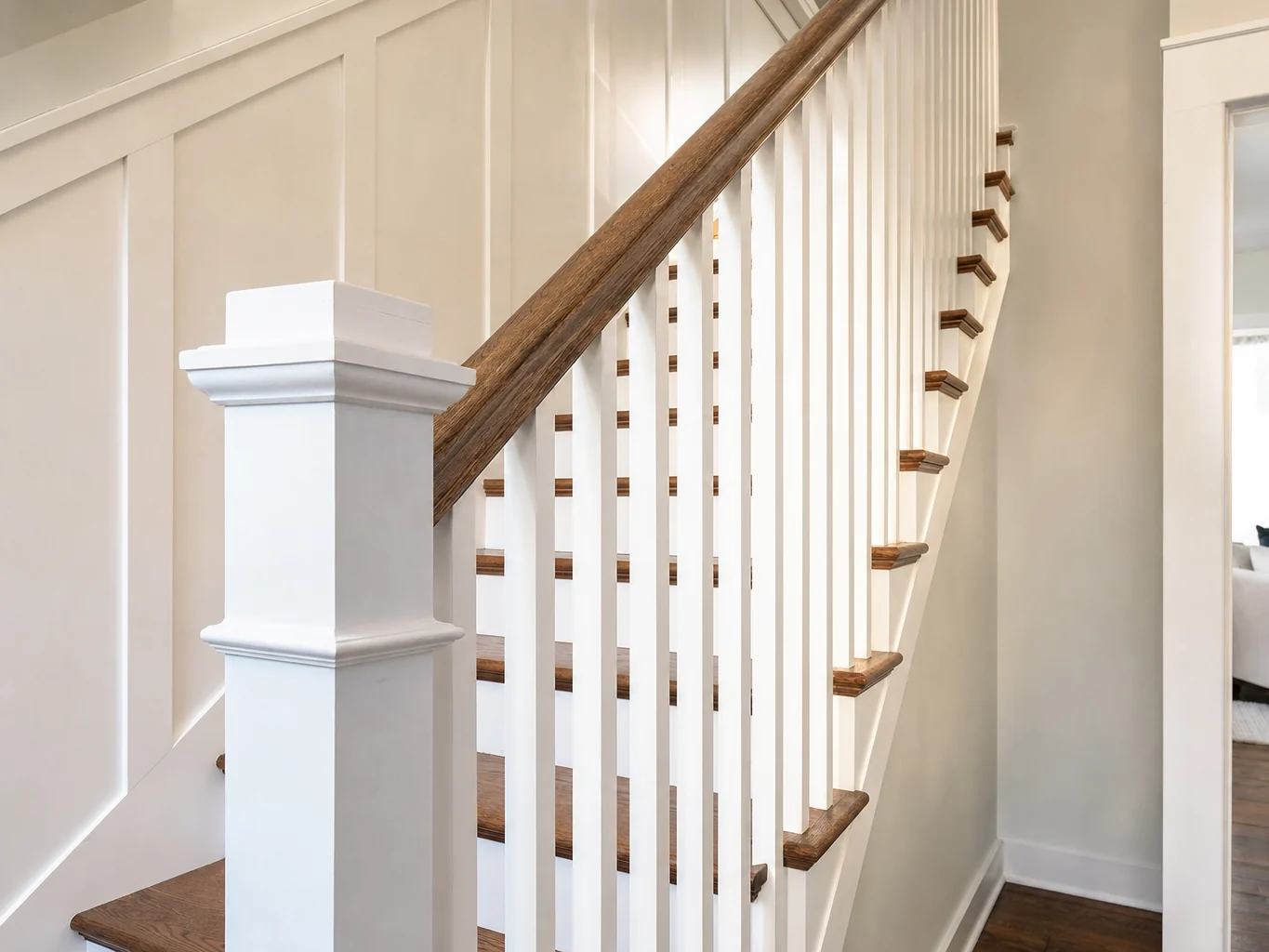 Staircase with square newel post and stained oak treads