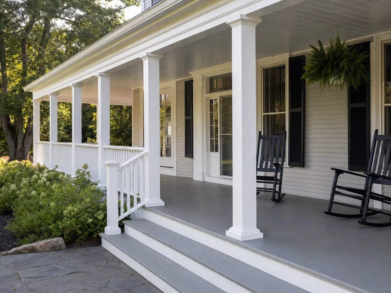 Covered farmer's porch with white columns and painted floor