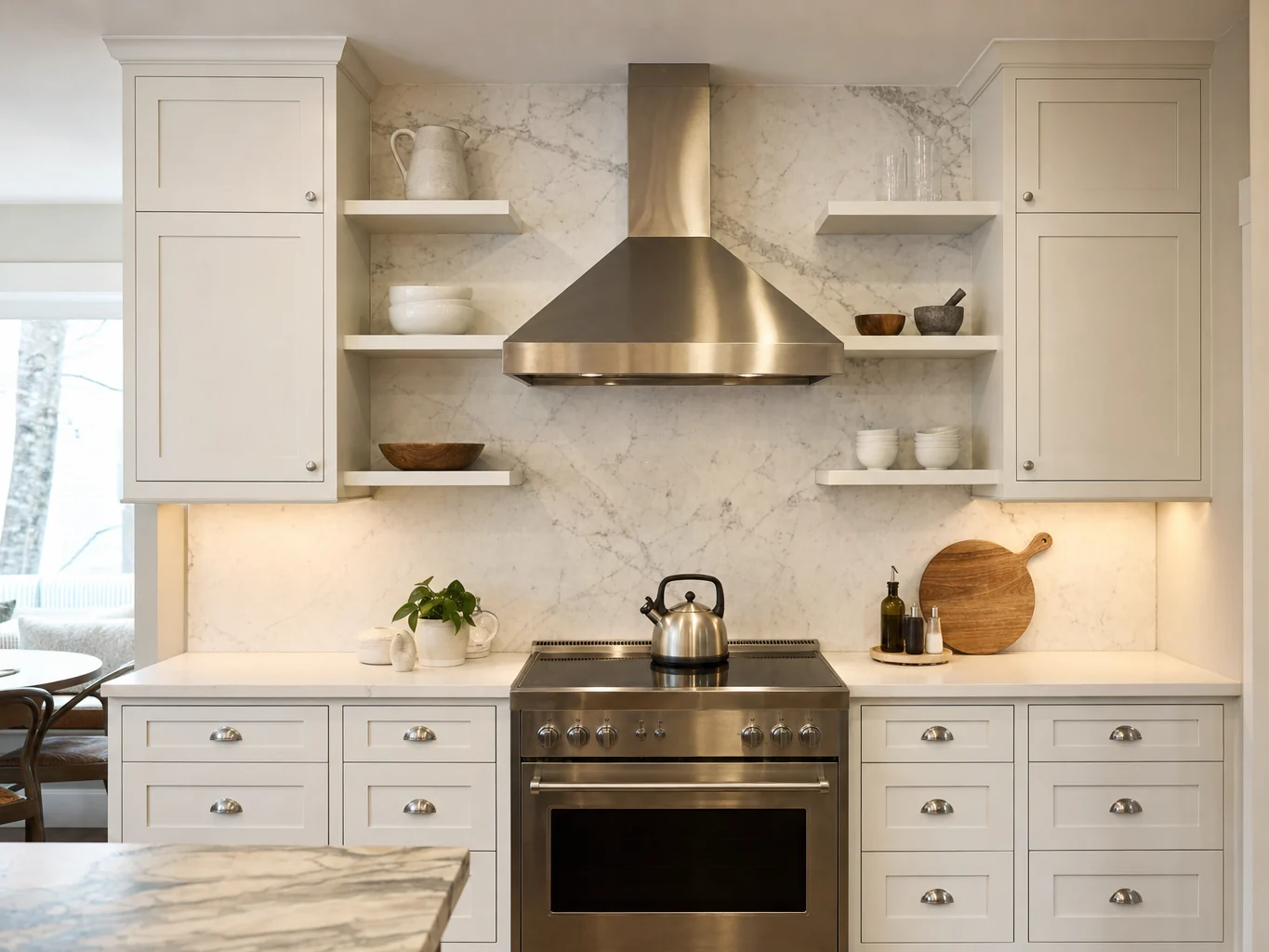 Kitchen range wall with stainless hood and marble backsplash