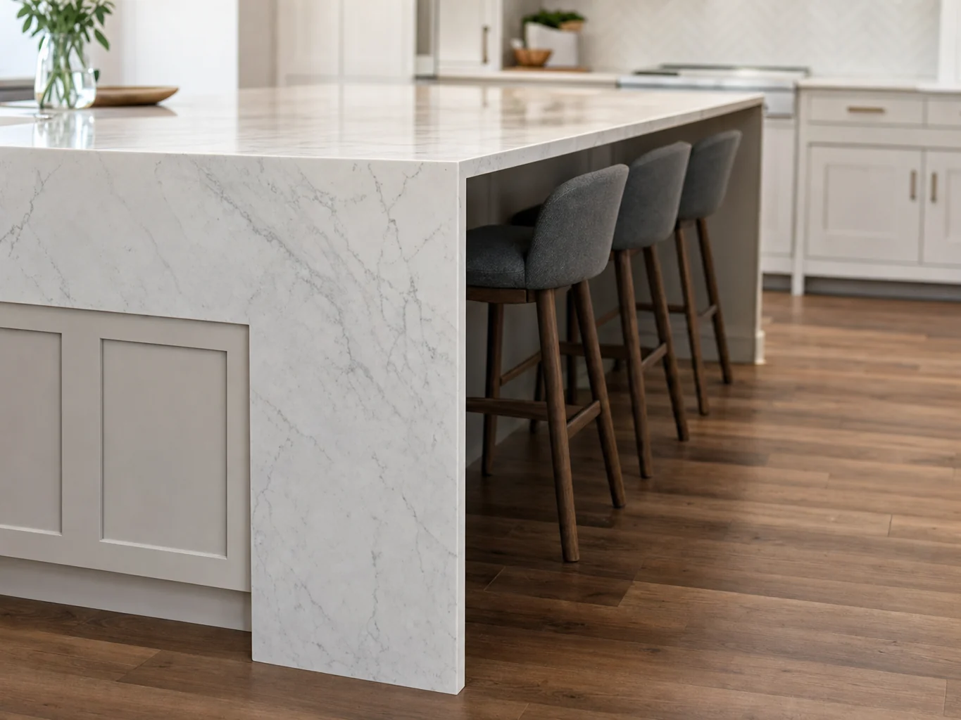 Kitchen island with waterfall quartz edge and counter stools