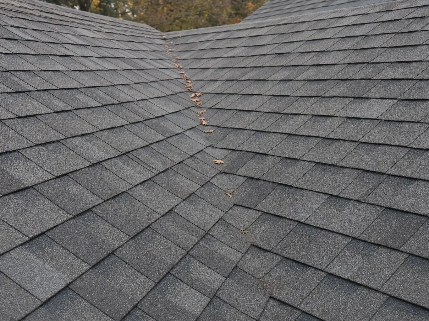 Finished roof valley with shingles woven cleanly through