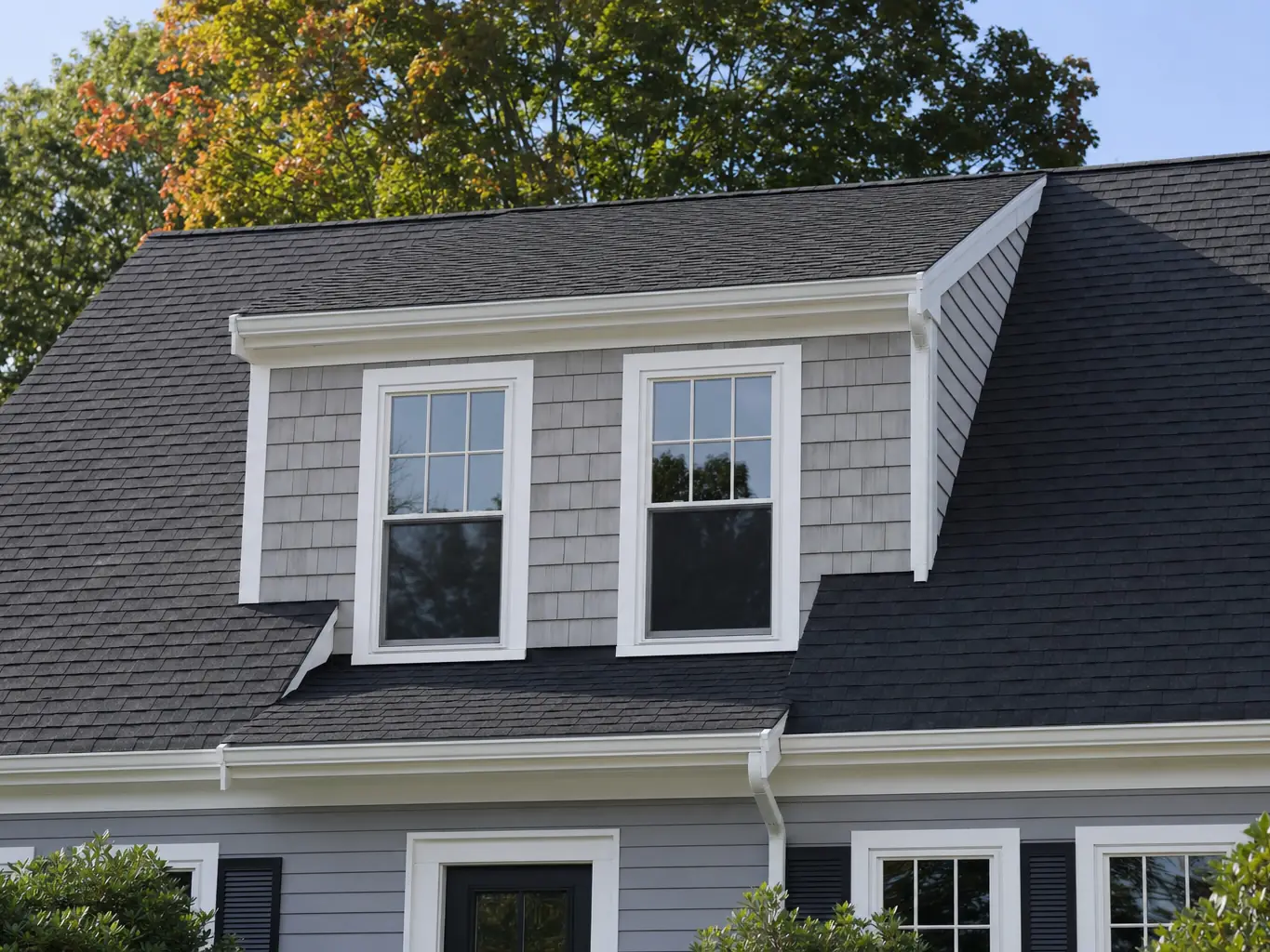 Shed dormer with new shingles and white trim