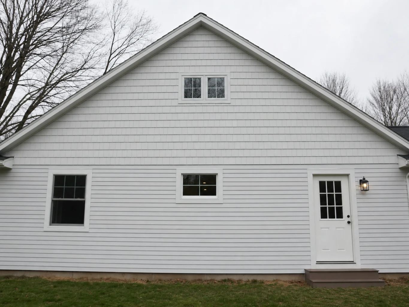 Rear elevation with new shake siding in the gable and lap siding below