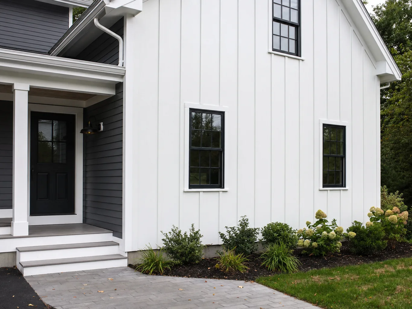 White board and batten siding meeting dark grey lap siding